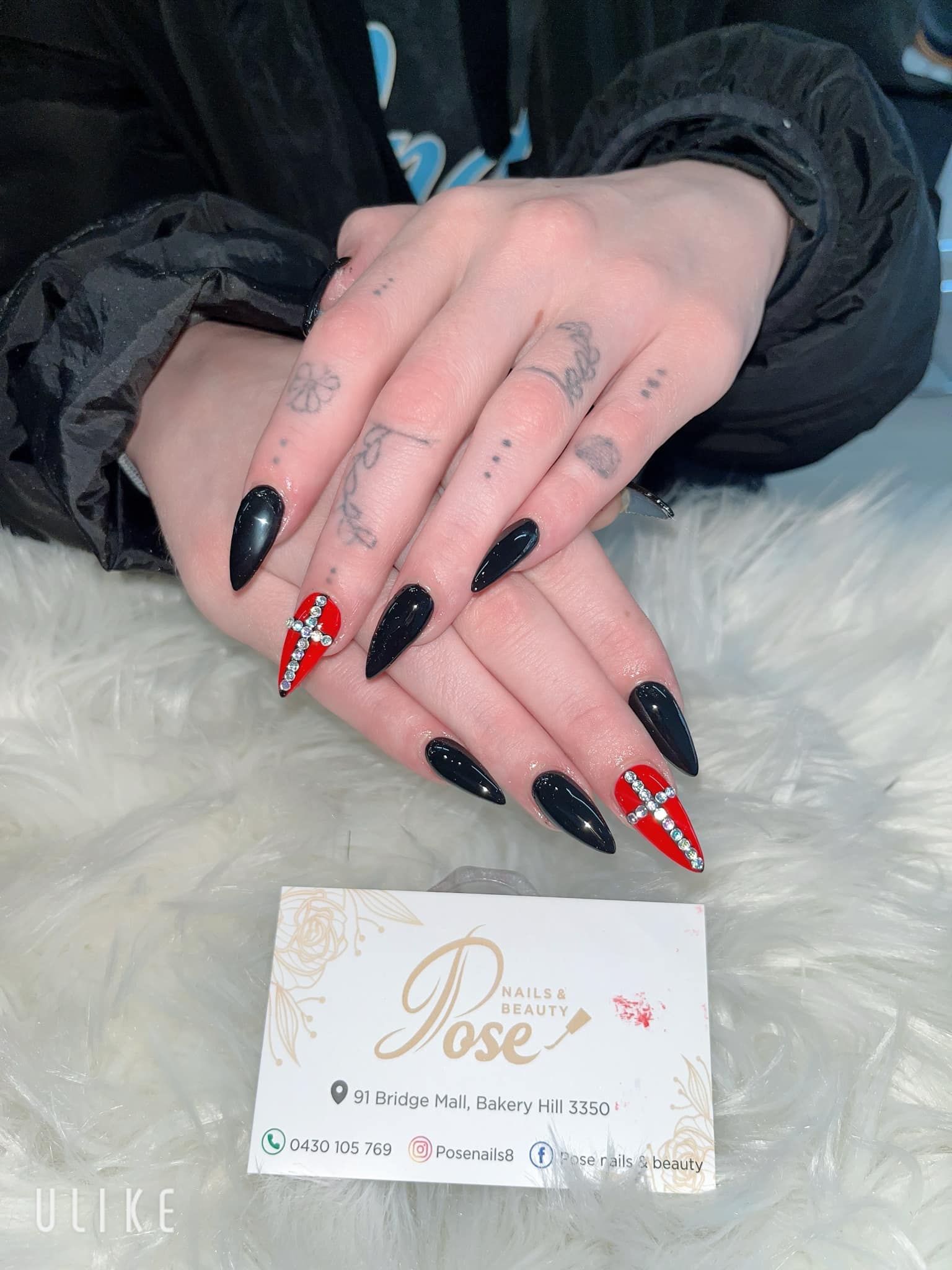 Black stiletto nails with red rhinestone accent nails