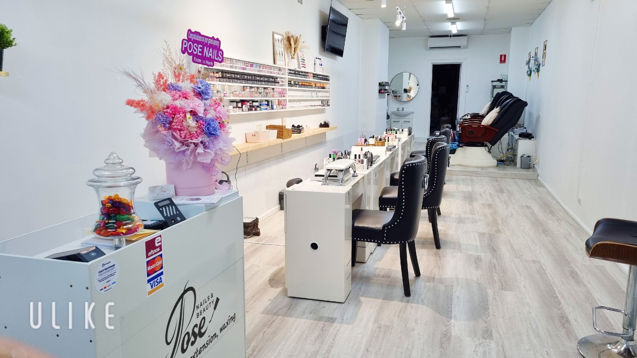 Inside Pose Nails and Beauty: manicure stations, polish wall and pedicure chairs