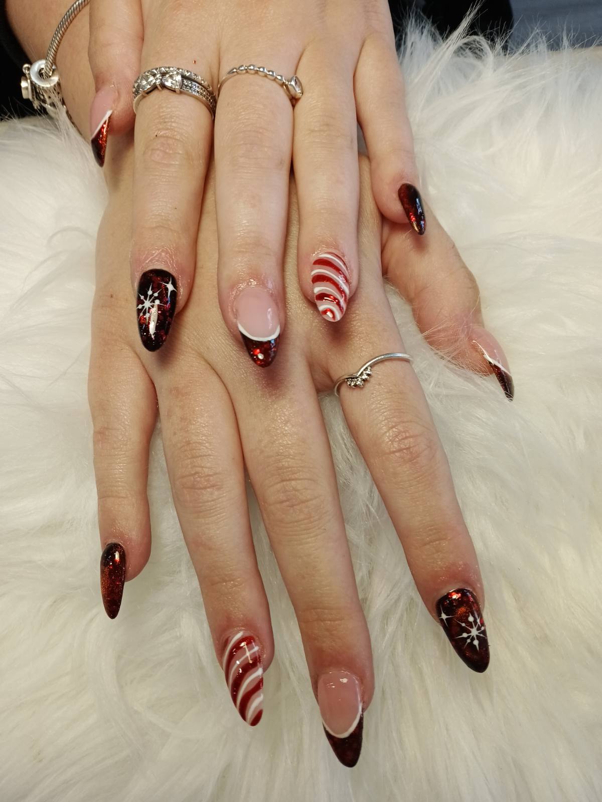 Deep red glitter nails with candy stripe and snowflake accents